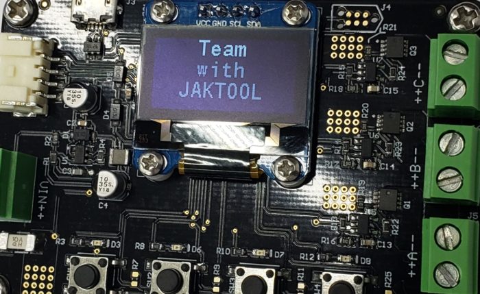 A closeup of circuit board with a screen that reads "team with Jaktool"