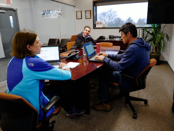 Jaktool employees going over proposals around a conference table