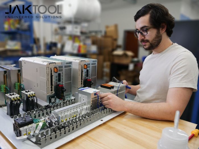 An employee working on a complex circuit